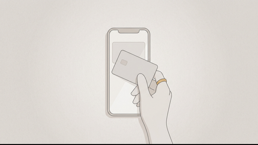 A bank card held flat against a phone screen to match the drawn card