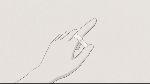 A thin paper strip wrapped around the base of a finger with a pen mark where it overlaps
